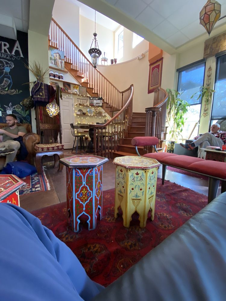 Painted Moroccan side tables at the foot of the stairs