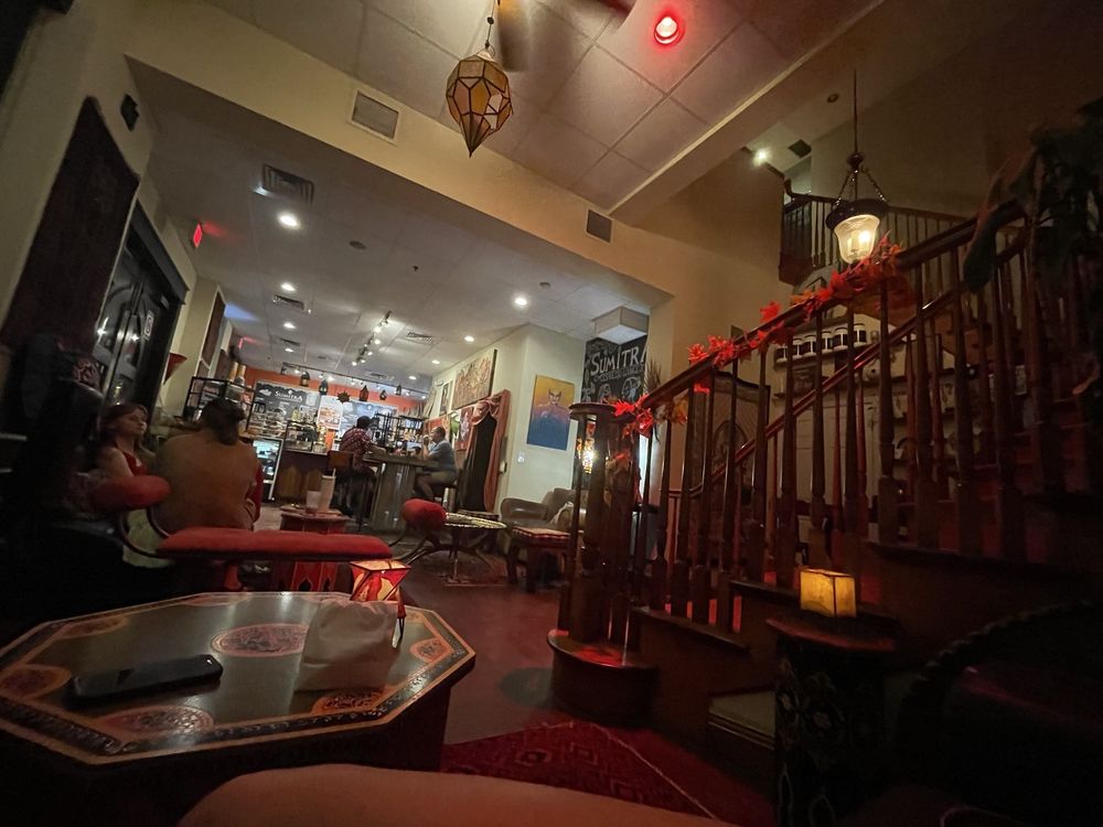 SumitrA's downstairs room at dusk with red lanterns along the stair rail