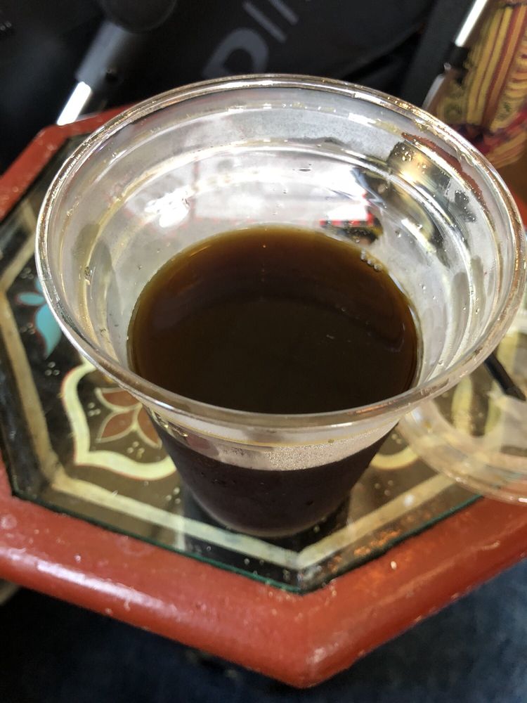 A cold brew in a glass on a hexagon tile tray