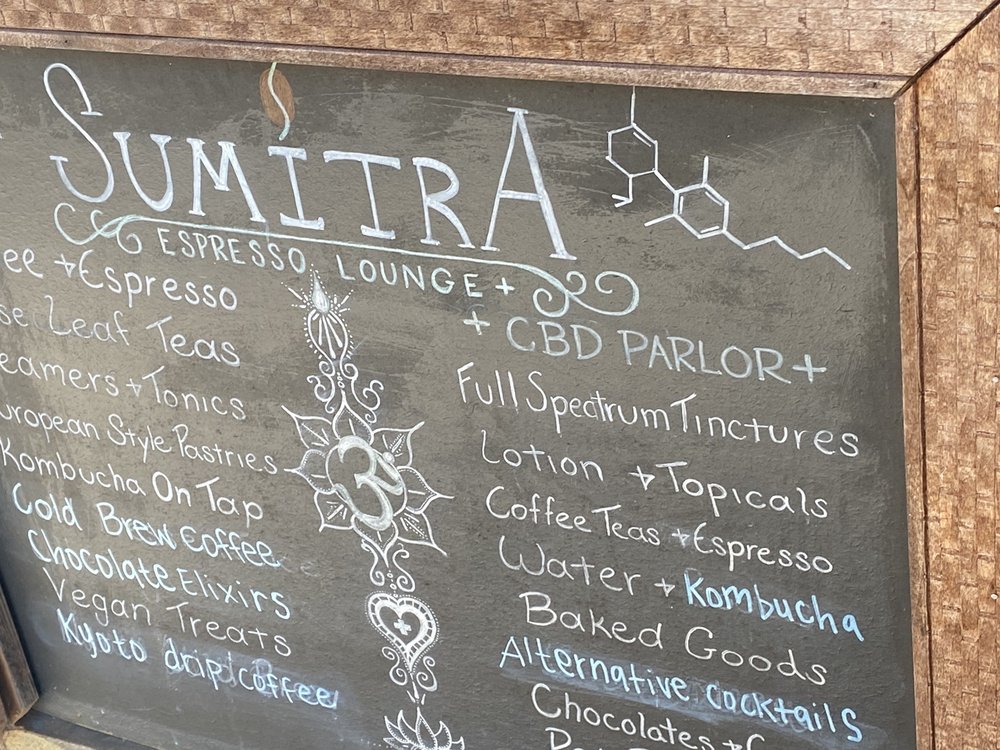 SumitrA's chalkboard listing the CBD parlor alongside coffee, tea and kombucha