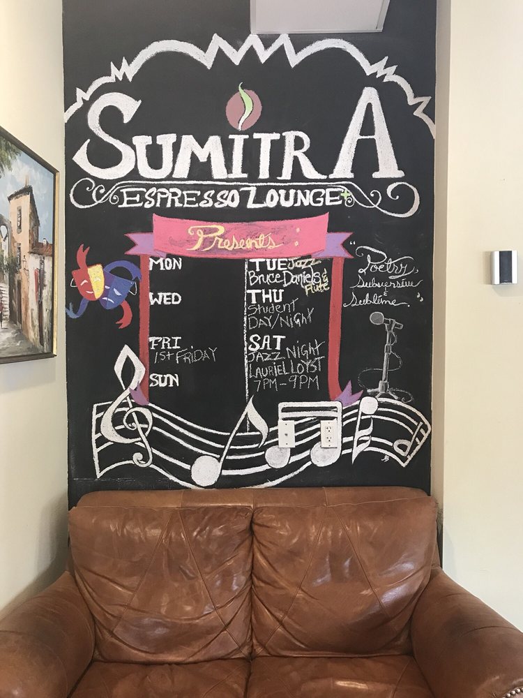 SumitrA's chalk mural announcing music and poetry over a leather couch