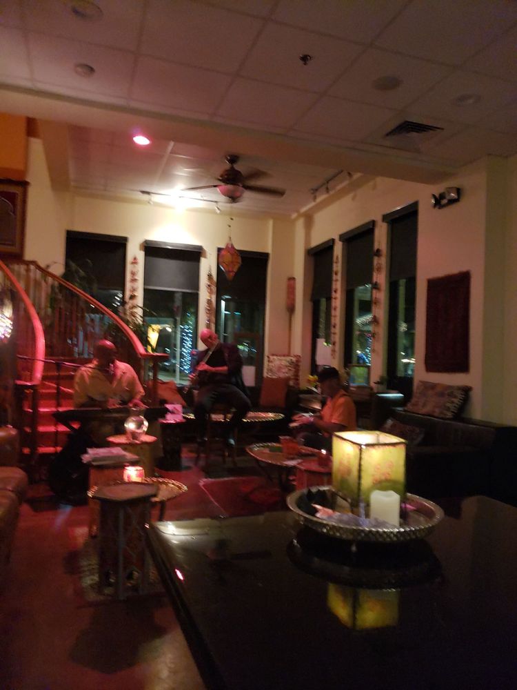 SumitrA's lounge in lamplight, guests at low tables