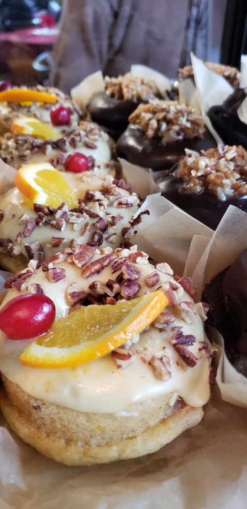 Iced pastries topped with orange slices and pecans in SumitrA's case