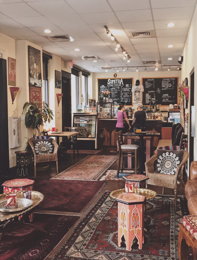 Patterned rugs and painted tables down the length of the room