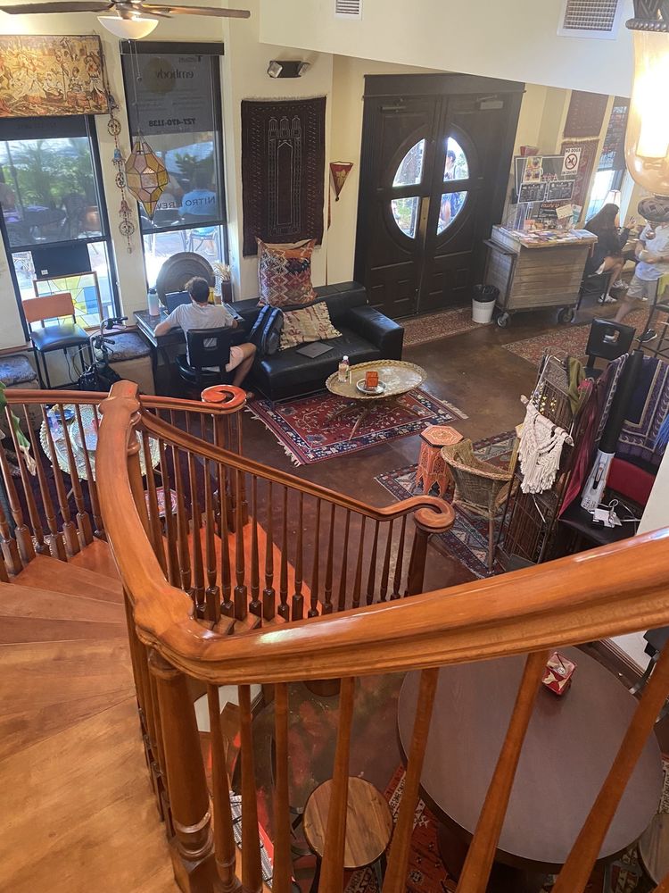 Looking down from SumitrA's staircase onto rugs, couches and the front doors