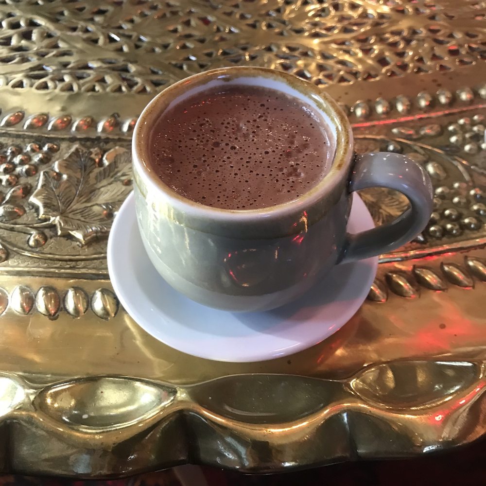Mayan drinking chocolate in a grey cup on SumitrA's hammered brass table