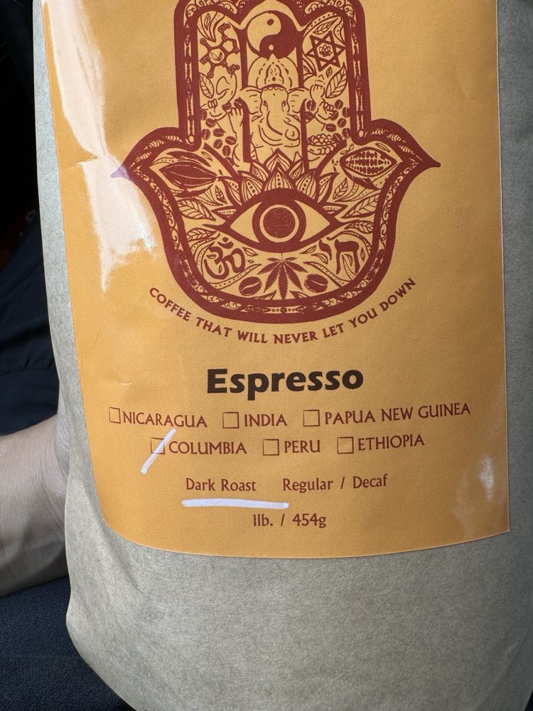 A bag of SumitrA espresso beans printed with a hamsa, origins listed below