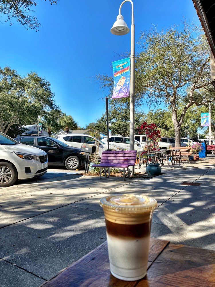 Iced latte on outdoor patio with Gulfport street view