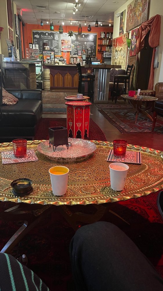 Moody lounge atmosphere with Moroccan lanterns and brass tables